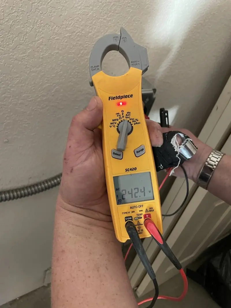 Voltage testing with clamp meter during Whole House Surge Protector in Akron